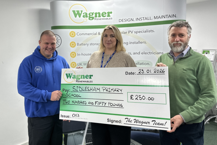 a male and female representaive from Sidlesham Primary School receiving a cheque for £250 from Wagner Rnewables.